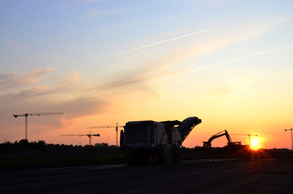 image shows asphalt Australia working a large road grading machine